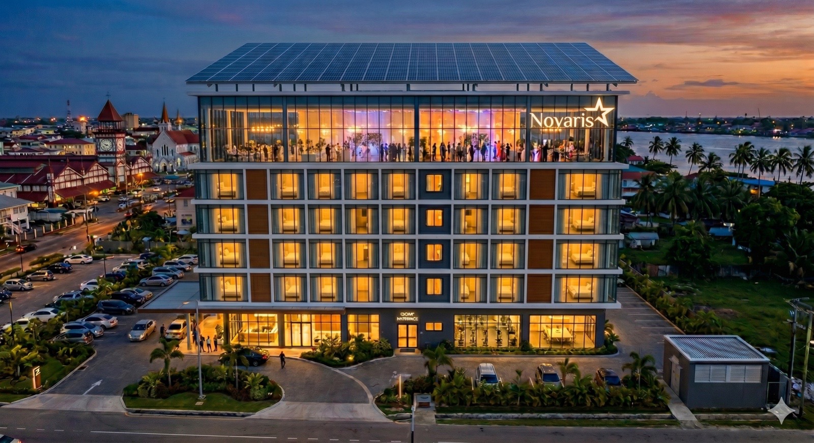 Novaris International building at twilight, Georgetown, Guyana, with rooftop event hall lit up